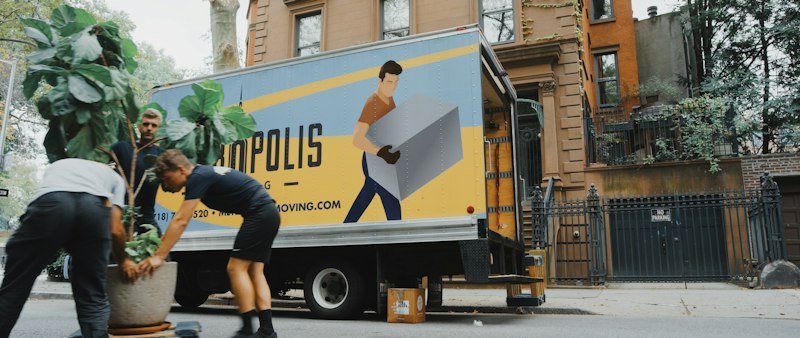 Professional crew carrying heavy furniture with care